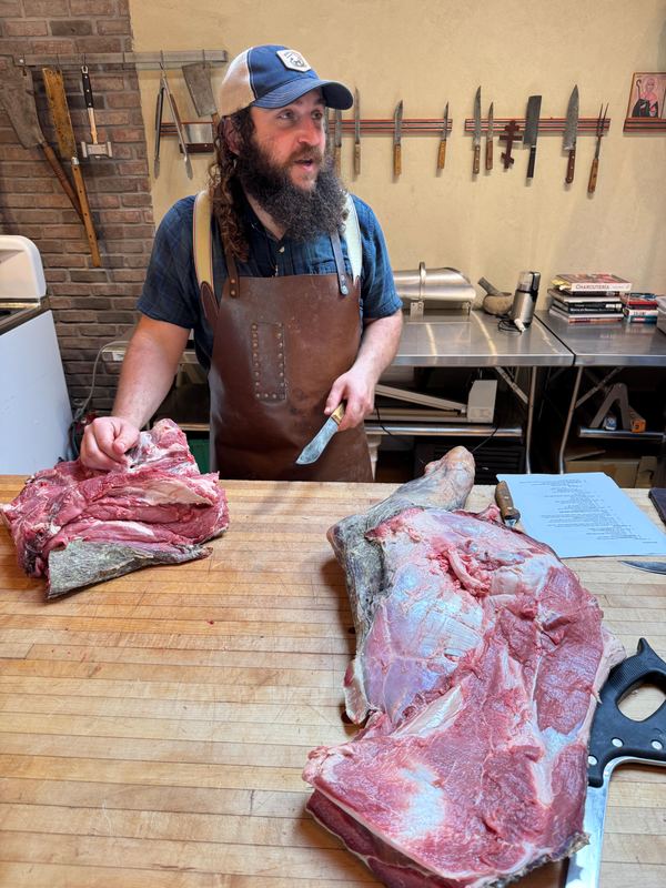 A butchery master class at a wooden block.