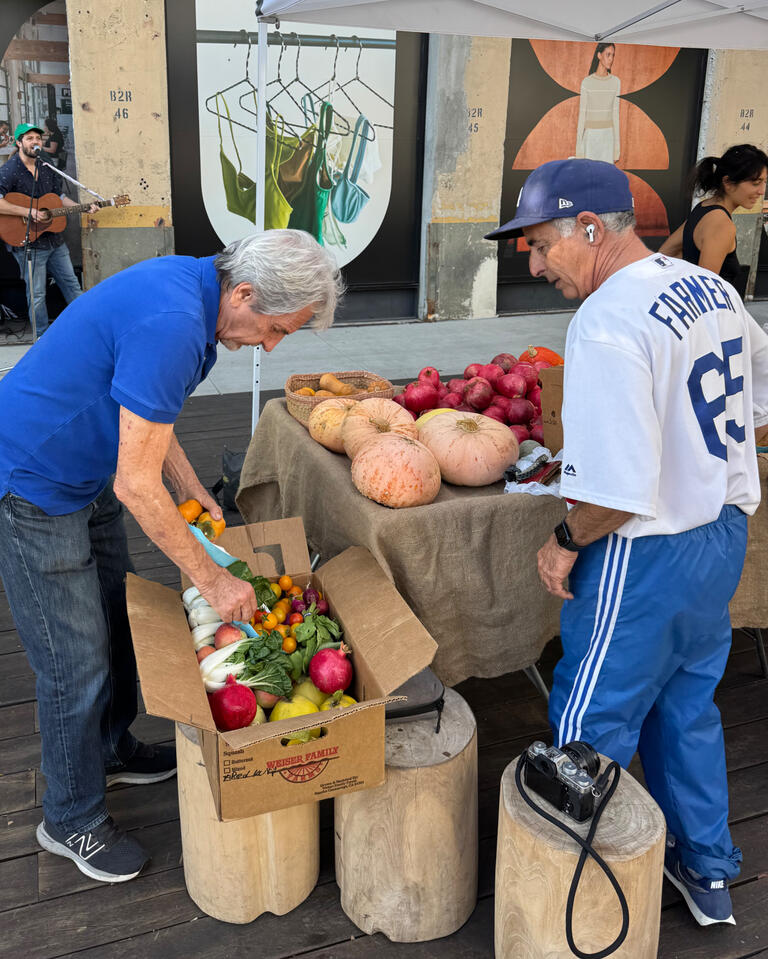 Alex Weiser hand selecting produce for one of his farm boxes. A lifelong LA Dodgers fan, he was gifted this jersey by the team.