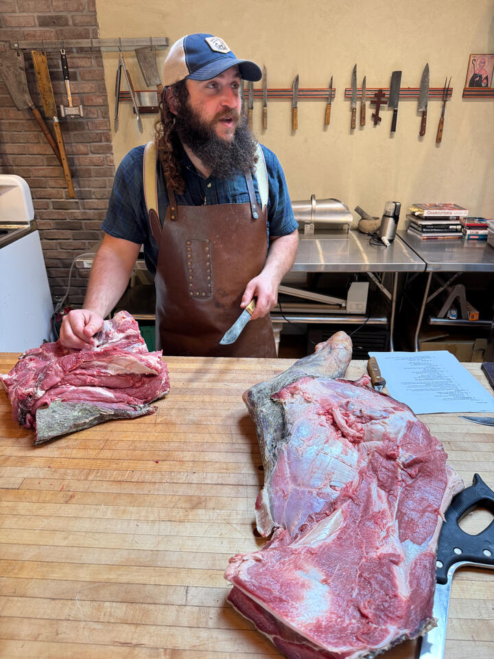 Dylan Boeken leading a master class in beef butchering. The group would select a cut for Chef Courtney to cook that night. Bavette &amp; neck!